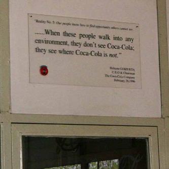 Coca-cola plaque being pretty honest about world domination